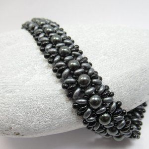 Hand woven bracelet with dark grey Swarovski pearls